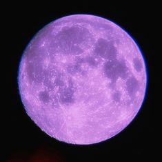 the bright purple moon is shining brightly in the dark sky