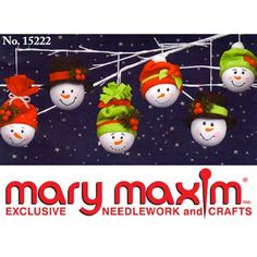 christmas ornaments with snowmen and hats hanging from a string on a snowy night background