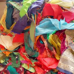 many different colored ribbons are piled on top of each other