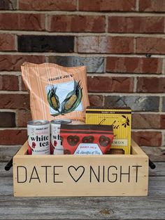 a wooden crate filled with drinks and snacks