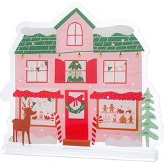 a paper cut out of a pink house with christmas decorations on the front and windows