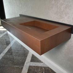 a brown box sitting on top of a counter next to a black object in the corner