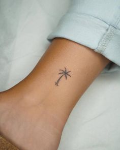 a small palm tree tattoo on the ankle