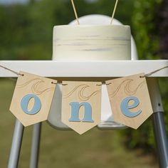 a cake on a table with one sign hanging from it