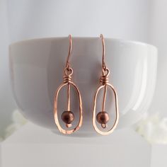 A pair of rustic, casual lightweight drop earrings individually handcrafted from hammered uncoated natural copper wire and embellished with an antique copper bead on hand formed French earwires.  Because each pair of earrings is made to order by me in my studio, no two pair are identical.  Casual and cheerful, they make a welcome gift for all women on your list for any giving occasion.  A pretty stocking stuffer surprise for her. Jewel Crafts, Hammered Copper Jewelry, Brass Earrings Handmade, Antique Bronze Jewelry, Jewelry 2024, Copper Earrings Handmade, Hammered Copper Earrings, Wire Jewelry Ideas, Washer Jewelry