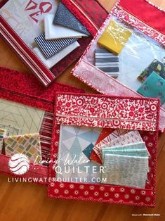 several different types of quilts laid out on a wooden floor with the words living water quilt