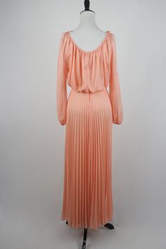 "1970s maxi dress. Peach colored light weight sheer polyester fabric on the outside and lined with an opaque nylon fabric. Long sleeves are unlined and are open from the shoulder to about the elbow with elastic at the wrists. Blousy top, elastic waist, and accordion pleated skirt. There is not a lot of stretch to the waist. Skinny fabric cord belt. Fastens down the back with a metal zipper. Only labels are a size 11/12, ILGWU, and dry clean only. Freshly laundered. (I have to laugh when polyeste Vintage Chiffon Maxi Dress For Spring, Spring Off-shoulder Lined Maxi Dress, Flowy Peach Maxi Dress For Party, Peach Flowy Maxi Dress For Party, Peach Floor-length Maxi Dress For Spring, Spring Peach Floor-length Maxi Dress, 1970s Dresses, Hawaiian Dress, Peasant Dress