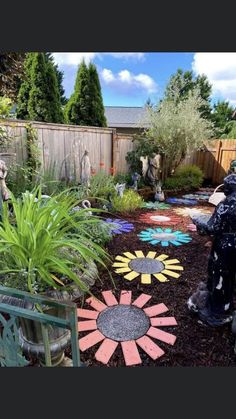 an outdoor garden with flowers and plants in the center, surrounded by landscaping materials that look like sunflowers