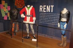 three mannequins dressed in costumes on display