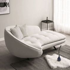 a white couch sitting on top of a rug in a living room