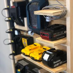 there are many different types of tools on the shelves in this garage storage area, including drillers and batteries