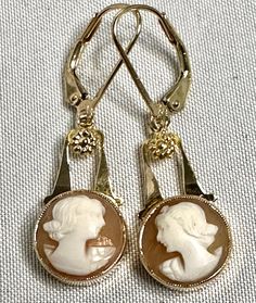 Lovely antique carved cameo earrings. The cameos are set in 10K gold mountings and have 10K French hinge back findings. The earring measure 1-1/4 inches long. The cameos measure 7/16 inch in diameter. The earrings weigh 2.7 grams. Excellent condition. Please email with any questions or special requests. Free shipping in the United States. Cameo Earrings, 10k Gold, Favorite Jewelry, Vintage Antiques, Jewelry Earrings Dangle, Etsy Earrings, Dangle Drop Earrings, Dangle Earrings, Jewelry Earrings