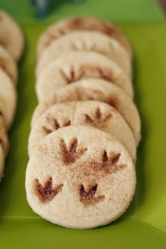 some cookies are arranged on a green plate