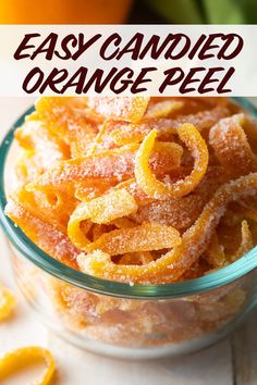 orange peels in a glass bowl with text overlay that reads easy candied orange peel