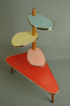 three tiered trays on top of each other in different colors and shapes,