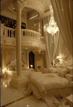 a large bed sitting under a chandelier next to a white couch in a bedroom