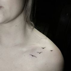 a woman's chest with two birds on it