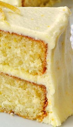 a slice of cake with white frosting on a plate