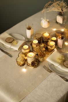 the table is set with candles and plates