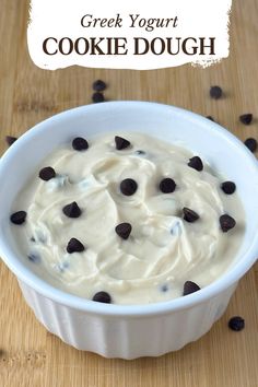 a white bowl filled with cookies and cream on top of a wooden table next to chocolate chips