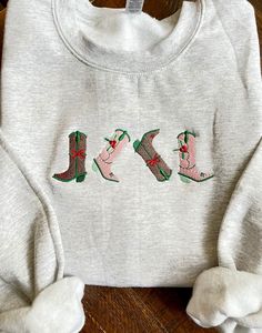 Embroidered Christmas Cowgirl Boots sweatshirt, * this design is available on several color sweatshirts listed !  - Swetashirt  is 50%cotton and 50%polyester. -This is unisex sweatshirt fits true to size .  -Size chart is listed in images!  -Size up for oversize look! **Shirt is made to order, and processing times is estimated 5-7 business days!  *Due to nature of Handmade goods this order is not allowed for returns or exchanges, but if you have any concerns, please do contact me and I would be Casual Winter Sweater With Custom Embroidery, Cowboy Like Me Embroidery, Western Embroidered Sweatshirt, Casual Christmas Sweatshirt With Custom Embroidery, Embroidery Cowboy, Cowgirl Era Sweatshirt, Embroidered Cowgirl Boots, Cowboy Like Me Sweatshirt, Embroidered Western Shirt