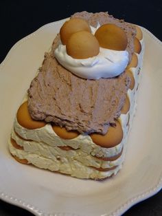 a piece of cake on a white plate with eggs on top and whipped cream in the middle