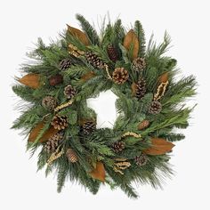 a christmas wreath with pine cones and leaves