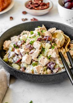 a bowl filled with chicken salad next to other dishes