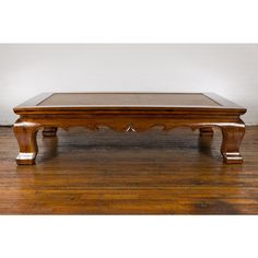 a wooden coffee table sitting on top of a hard wood floor