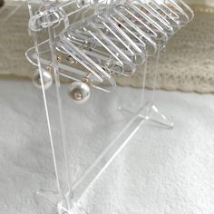 there is a clear acrylic rack with earrings on it