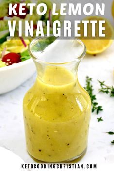 a glass bottle filled with keto lemon vinaigrete next to a salad