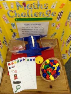 a table topped with lots of toys on top of a wooden table next to a sign