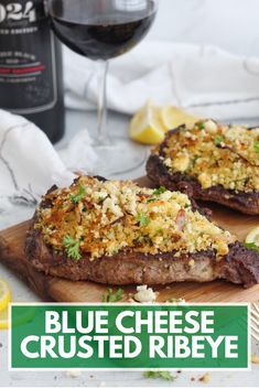 blue cheese crusted ribeye on a cutting board next to a glass of wine