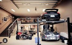 two cars are parked in a garage next to each other and one car is upside down