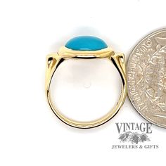 The combination of yellow gold and turquoise, though not seen as often as other metals, offers a striking contrast. The round cabachon fine turquoise in this estate ring is often referred to as "robin's egg" blue with almost no secondary coloration, and is usually considered the most desirable color. It is bezel set in a polished 18 karat yellow gold setting with triangular gold buttresses incorporated into the shoulder design, tapering down to a 2.5 mm shank. The ring is size 5.5. 14k Yellow Gold Turquoise Cabochon Ring, Classic Gold Turquoise Ring With Round Shape, Classic Yellow Gold Turquoise Ring, Blue Turquoise Oval Cabochon Ring In 14k Gold, Blue Turquoise 14k Gold Oval Cabochon Ring, Gold Turquoise Cabochon Ring In 14k Gold, Classic Yellow Gold Turquoise Cabochon Ring, Blue Oval Cabochon Turquoise Ring In 14k Gold, Classic Cabochon Turquoise Ring In Yellow Gold