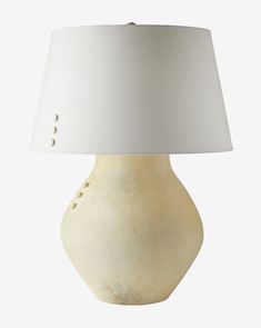 a table lamp with a white shade on the top and buttons on the bottom side