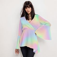 * Elevate your style with our Ombre Rainbow Top, a perfect blend of vintage charm and modern flair for women. * Embrace the 70s vibe with this Boho Top featuring groovy bell sleeves and a high empire waistline. * Made for the free-spirited, this 70s Disco Top boasts a stunning rainbow ombre pattern print. * Crafted with care, this Hippie Top combines comfort and style with its wrap top bodice design. * Stand out from the crowd in this Bohemian Top Women, perfect for adding a pop of color to any outfit. * Whether you're dancing the night away or soaking up the sun, this Ombre Top Women is sure to turn heads. Designed in California by Trendy Hip Buys. Handmade to order from overseas. 100% Polyester ● Fabric: 100% polyester ● Regular fit ● V-neck, Bell Sleeves ● Fabric weight: 80gm ● Care Ins Long Sleeve Summer Tops With Rainbow Print, 70s Inspired Multicolor Summer Tops, 70s Inspired Multicolor Tops For Spring, Spring Festival Multicolor Blouse, Multicolor Hippie Blouse For Fall, Spring Hippie Bell Sleeve Tops, Bohemian Multicolor Party Tops, Fall Hippie Multicolor Blouse, Trendy Long Sleeve Festival Blouse