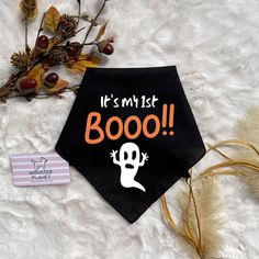 it's my 1st boo halloween dog bandana on a white blanket with dried flowers