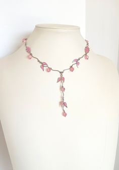 Girlish, romantic, minimal bib necklace, handmade vintage from the '90s. A really charmy, dainty piece of jewelry, light, elegant but eye catching. Silver tone metal garland is combined with light pink glass beads and enamel leefs charms. Short necklace, stands high at the neckline, but continues at a long bib of the same kind. Total length 41.00 with additional expand chain, bib length 8.50 cm. Please remember that it is not a new item, so there can be time signs on it. In perfect condition. 90s Beaded Necklace, Pink Wire Wrapped Necklace, Handmade Adjustable Feminine Necklace, Handmade Adjustable Feminine Necklaces, Necklace Stands, Minimal Vintage, Valentines Day Presents, Beaded Statement Necklace, Girlfriend Gift