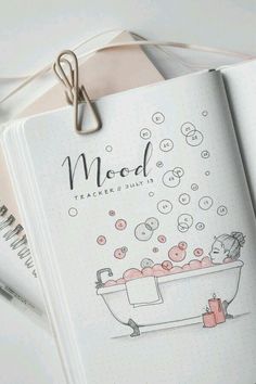 an open notebook with a drawing of a bathtub