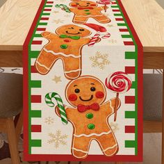 a table runner decorated with gingerbreads and candy canes