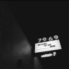 a black and white photo of the marquee sign for something to see here