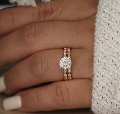 a woman's hand with a diamond ring on it