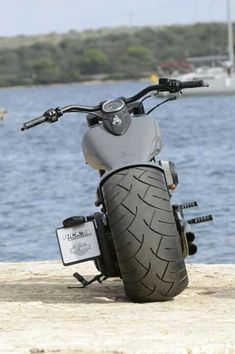 a motorcycle parked on the edge of a pier