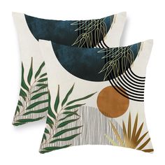 two pillows with palm leaves on them