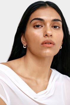 Find poetry in the everyday with our Sisley Hoops. Elegant and ever-so-chunky, these oval ornaments are crafted from sterling silver with either 18k gold or white gold plating to complement any look. Featuring a post back closure and polished finish. Each pair includes a Marcella-branded vegan leather travel case for safe storage and easy travel. | Available in one size. Approximately .5” (1.5 cm) in height, and .3" (.8 cm) in width. In silver, white gold plated sterling silver. In gold, 18KT ye Safe Storage, Easy Travel, Winter Clothing, Leather Travel, Travel Case, Gold Plated Sterling Silver, Gold Plating, Silver Color, Vegan Leather