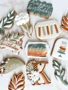 decorated cookies with happy birthday written on them are arranged in the shape of trees and leaves