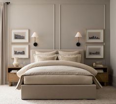 a large bed sitting next to two lamps on either side of the headboard and foot board