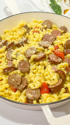 a skillet filled with pasta and sausage