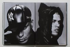 an open book with black and white photos of two men wearing baseball caps on their heads